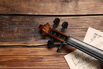 Wall Mural - Violin and music sheets on wooden table, top view. Space for text