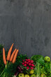 fresh vegetables carrot radish salad apples on grey table as background