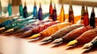 A pristine array of calligraphy pens, each inked in vibrant hues, poised gracefully on a textured writing surface