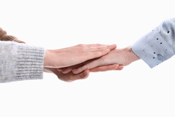 Wall Mural - Women holding hands together on white background, closeup