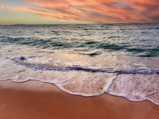 Wall Mural - Sunset scene with wave water in the Tropical summer beach with  sandy beach background