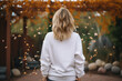 Fashion and style concept. Woman with white blank sweatshirt portrait. Girl standing back to camera in yellow autumn trees background. Model wearing white blank sweatshirt or sport jumper