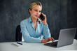 Business woman conducting negotiations online on phone and laptop