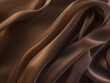 Abstract background of smooth flowing silk with soft wave of brown and black colors