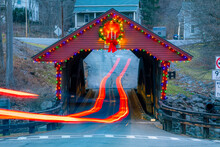 Light Trails Through A Timber One Lane Covered Bridge In The Town Of Newfield, Tompkins County NY With Holiday Lights.	