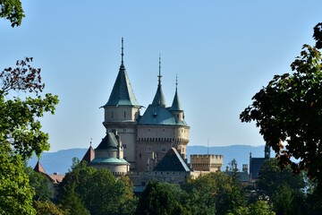 View from behind the trees of the old walls castle Bojnice Slovakia