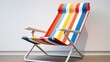A folding beach chair with vibrant stripe patterns, adding a splash of color to the white space.