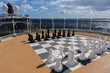 Open outdoor sun deck with large game of chess and figures onboard luxury cruiseship cruise ship ocean liner for entertainment and group game sports