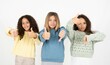© Roquillo - Three beautiful multiracial kid girls  showing thumbs up and thumbs down, difficult choose concept
