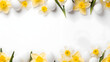 Top down view of an Easter border frame of daffodils and white eggs