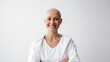 Portrait of a happy hairless bald woman woman girl looking at the camera on a white bright blurred studio background