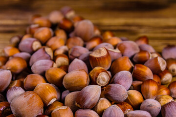 Sticker - Pile of the hazelnuts on wooden table