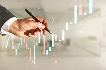 Poster - Man hand with pen working with abstract virtual financial graph on blurred office background, financial and trading concept. Multiexposure