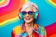 Matured funny woman with wrinkles in her face wearing a colorful headset and sunglasses isolate in abstract background, smiling happy senior woman wearing colorful fancy cloths close up portrait photo