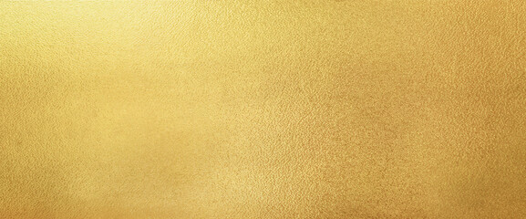 gold wall texture background. yellow shiny gold paint on concrete wall surface, vibrant golden luxur