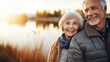 Smiling elderly couple fishing, blurry lake scene at sunrise. Conscious longevity.