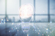 Abstract virtual idea concept with light bulb and human brain illustration on empty corporate office background. Neural networks and machine learning concept. Multiexposure