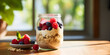 Overnight oatmeal with fresh berries in a glass, blurry window background 