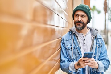 Sticker - Young bald man smiling confident using smartphone at street