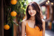 Asian woman model wearing an orange sundress in the garden