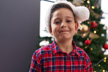 Canvas Print - Adorable hispanic boy smiling confident standing by christmas tree at home