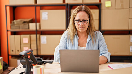 Sticker - Middle age hispanic woman ecommerce business worker using laptop at office