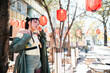 Portrait of an Asian woman against the background of Chinese lanterns. 