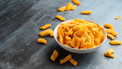 Crunchy Nacho cheese corn snack in white bowl