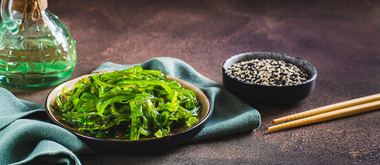 Poster - Traditional fresh seaweed and sesame salad on a plate on the table web banner