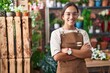 © Krakenimages.com - Young beautiful hispanic woman florist smiling confident standing with arms crossed gesture at florist