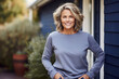 
Outdoor portrait of beautiful middle age 55 - 60 year old woman posing outside, wearing blue pullover