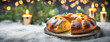 A traditional Rosca de Reyes cake rests on a snowy table, adorned with candied fruits, celebrating Epiphany. This festive dessert on Three Kings Day, candlelit setting, evoking the joy of the holiday.