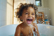 A happy baby during bath time. Child laughing in a bath tub