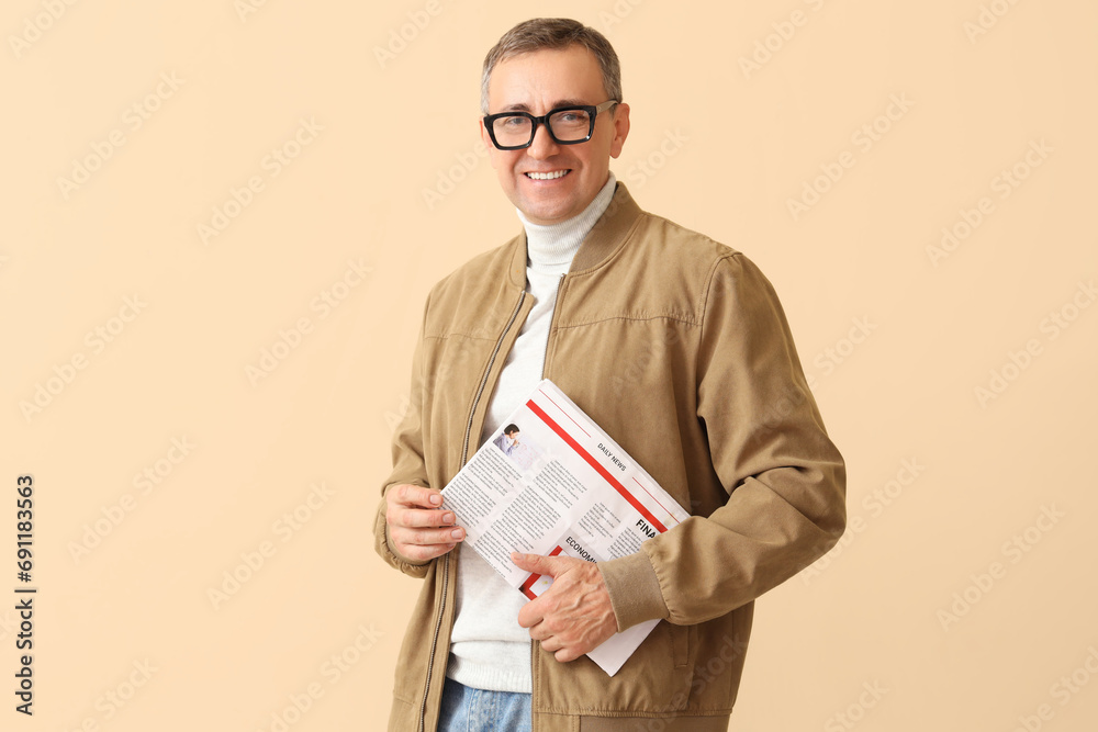 Mature journalist with newspaper on beige background