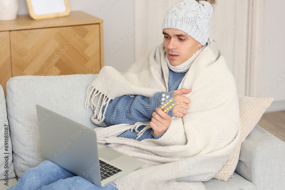 Ill young man showing pills to doctor at home