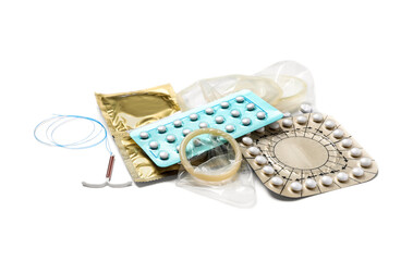 Contraceptive pills, condoms and intrauterine device isolated on white. Different birth control methods