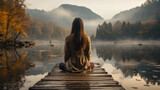 Fototapeta  - Young woman meditating on wooden pier early morning