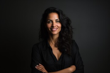 Wall Mural - Portrait of a beautiful young woman in a black shirt on a dark background