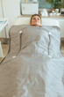 © Alliance - woman doing whiskey swaddling procedure in thermal blanket