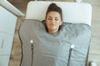 © Alliance - woman doing whiskey swaddling procedure in thermal blanket