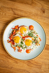 Wall Mural - fried eggs with vegetables on the table