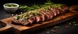 Flank steak grilled with chimichurri on table.