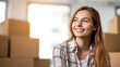 © red_orange_stock - Portrait of a beautiful young woman moving in a new home.