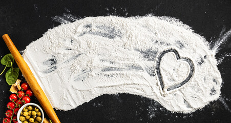 Aufkleber - Raw ingredients for cooking Italian dish pizza with a heart on flour, top view. Baking background concept