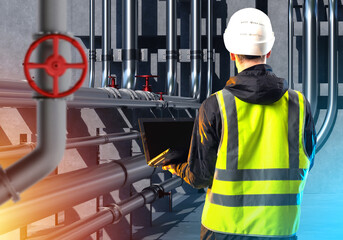 Poster - industrial worker with laptop. man engineer has back to camera. inspector inspects gas pipeline. pip