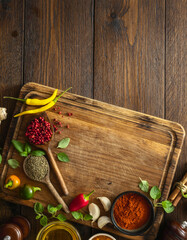 Canvas Print - Top view food cooking ingredients background with cutting board, various herbs, spices and olive oil on wooden background with copy space