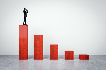 Aufkleber - Businessman with binoculars standing on top of red chart made of wooden bricks on light background. Crisis, finance and business forecast concept.