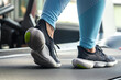 Woman's legs on a treadmill, shoes close-up, cardio workout.