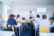 © Westend61 - Woman teaching to multi-ethnic students in classroom