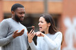 © PheelingsMedia - Angry woman scolding a man about phone content